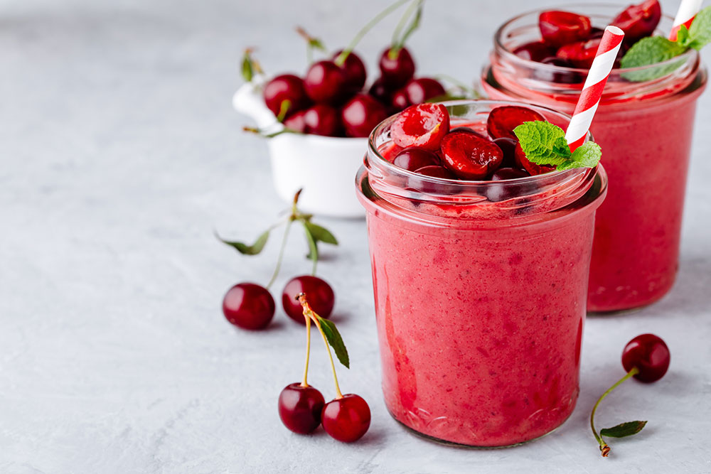 frozen cherry smoothy garnished with sliced cherries