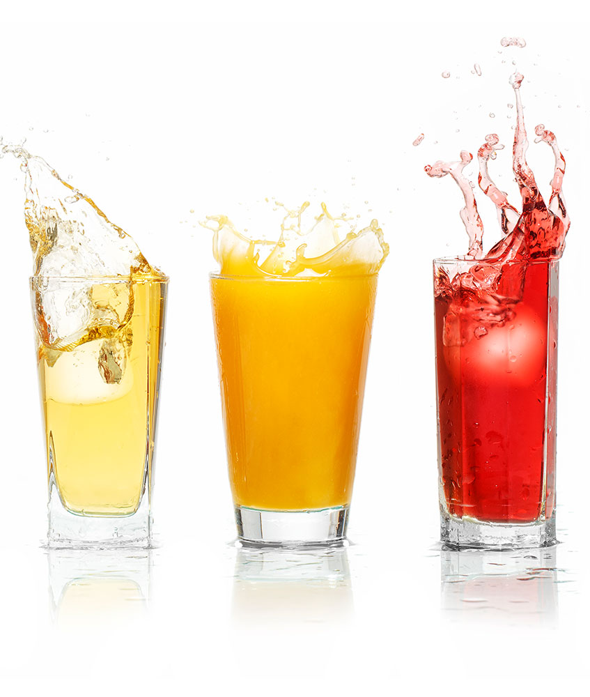 three juice glasses with their contents splashing out of the cups
